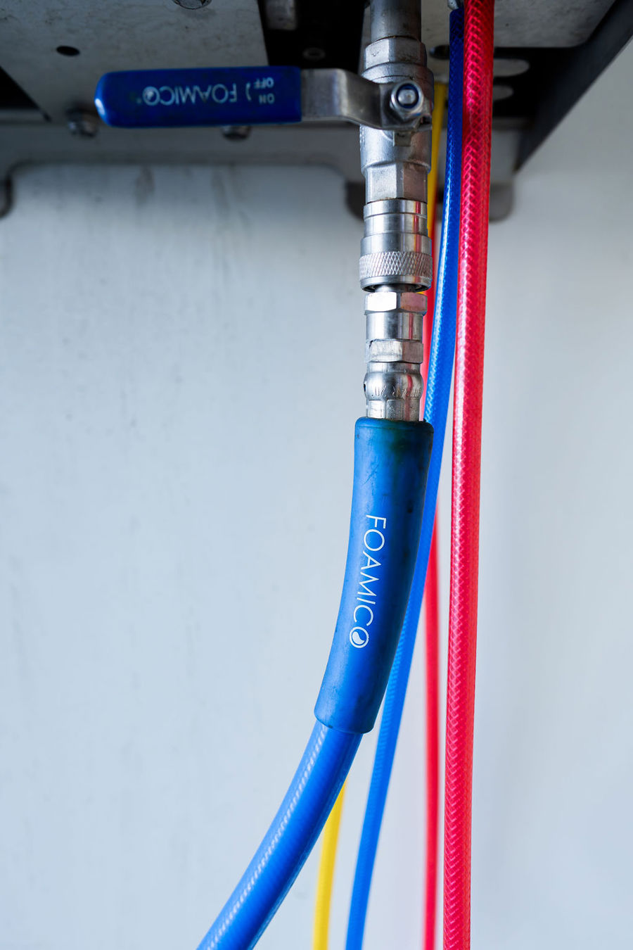 Close up of a Foamico coupling, valve and colour coded hoses
