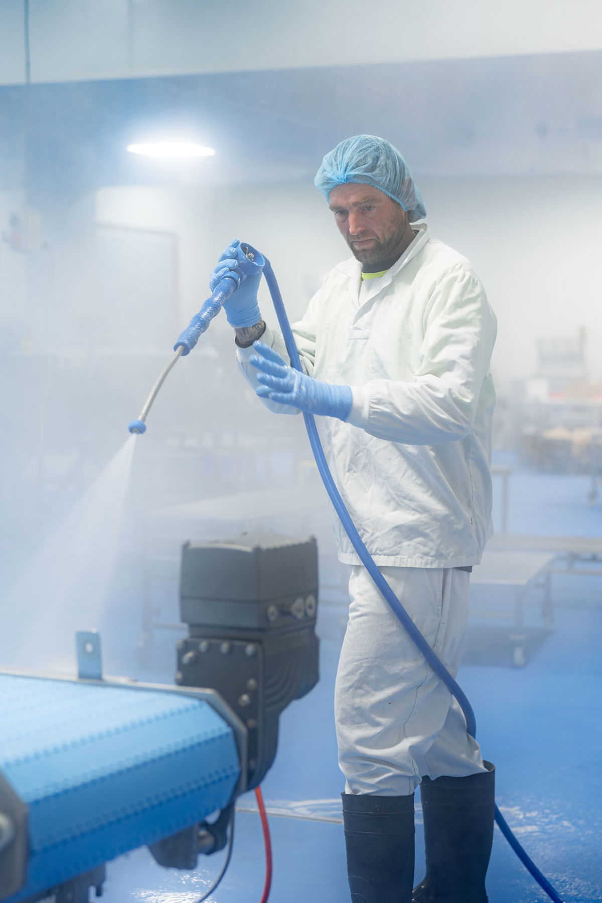 Operator cleaning with a Foamico hose and nozzle